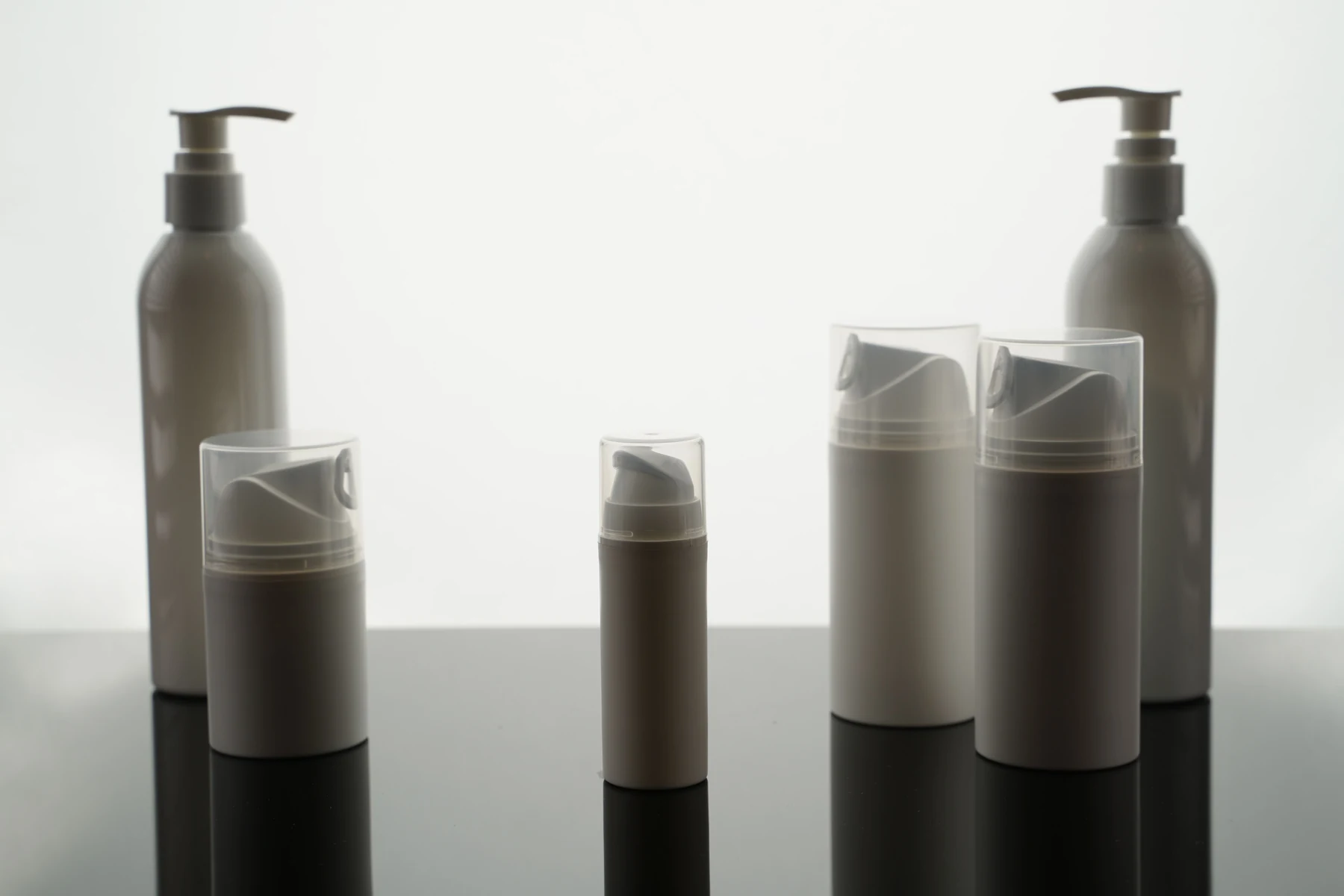 A selection of cosmetic pump bottles and packaging components